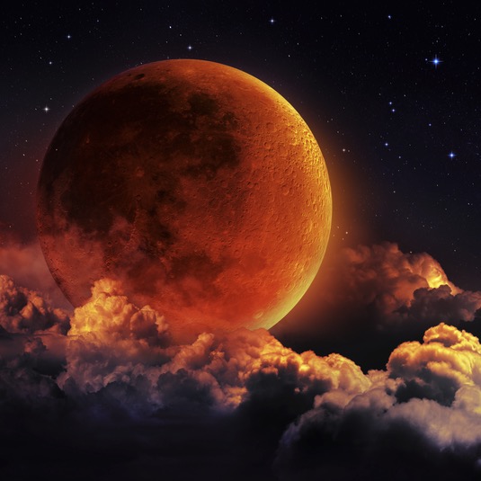 the moon in red over a sea of clouds at night - deposit photos