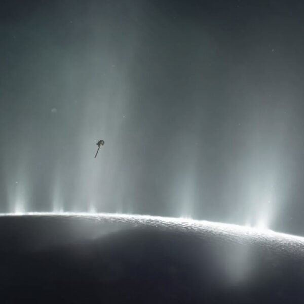 An illustration of NASA's Cassini orbiter soaring through a giant vapor jet over the moon Enceladus (Image credit: NASA/JPL-Caltech)